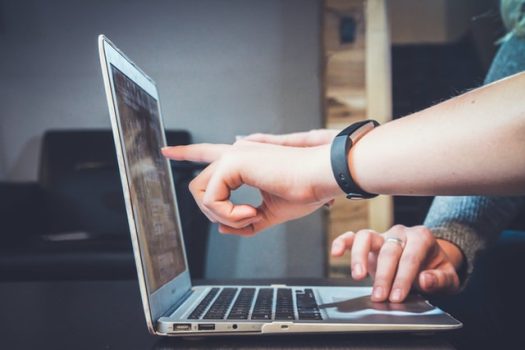 Deux personnes consultent un site d'e-commerce sur un ordinateur portable